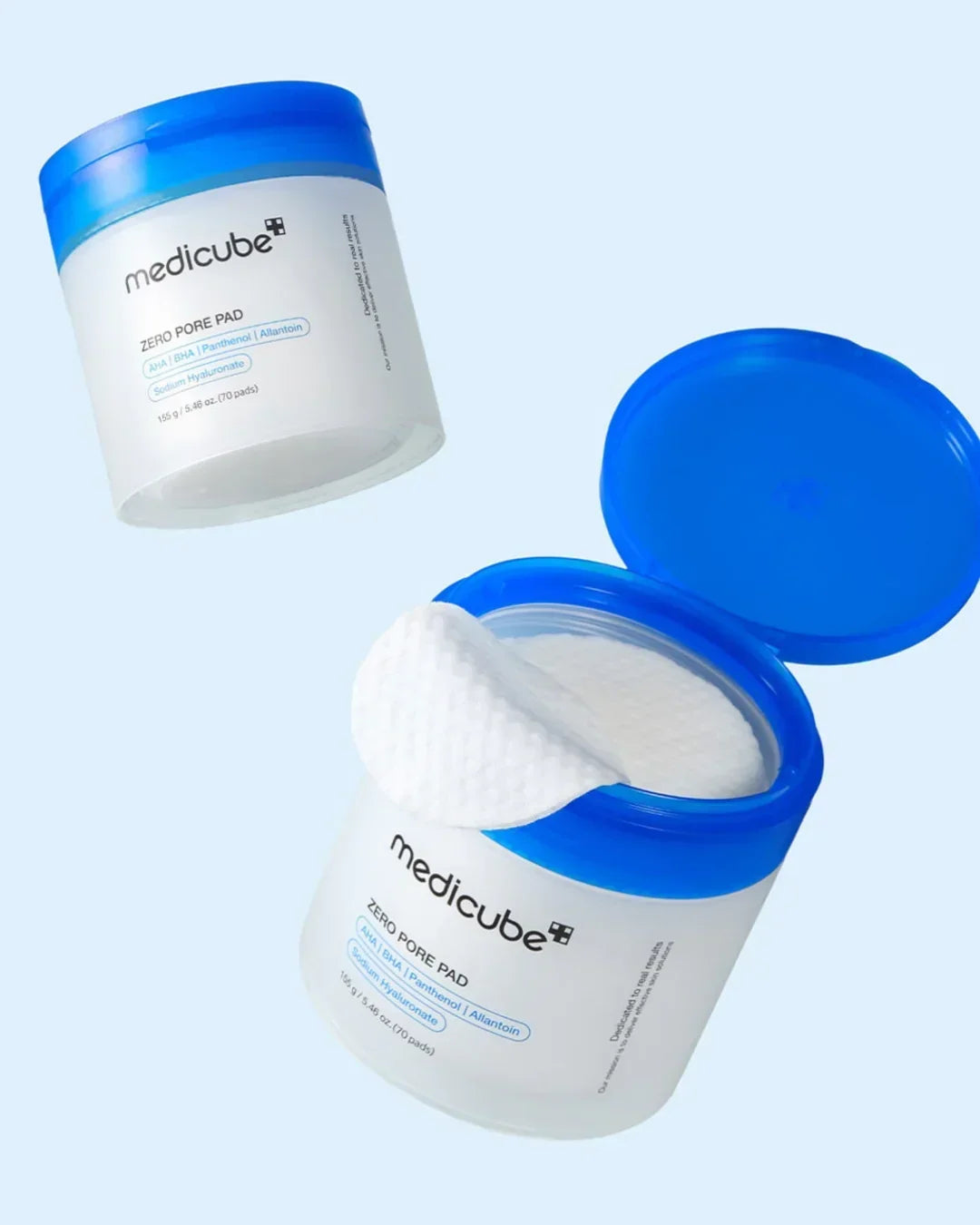 Medicube Zero Pore Pad containers with blue lids and textured cotton pads for skincare exfoliation