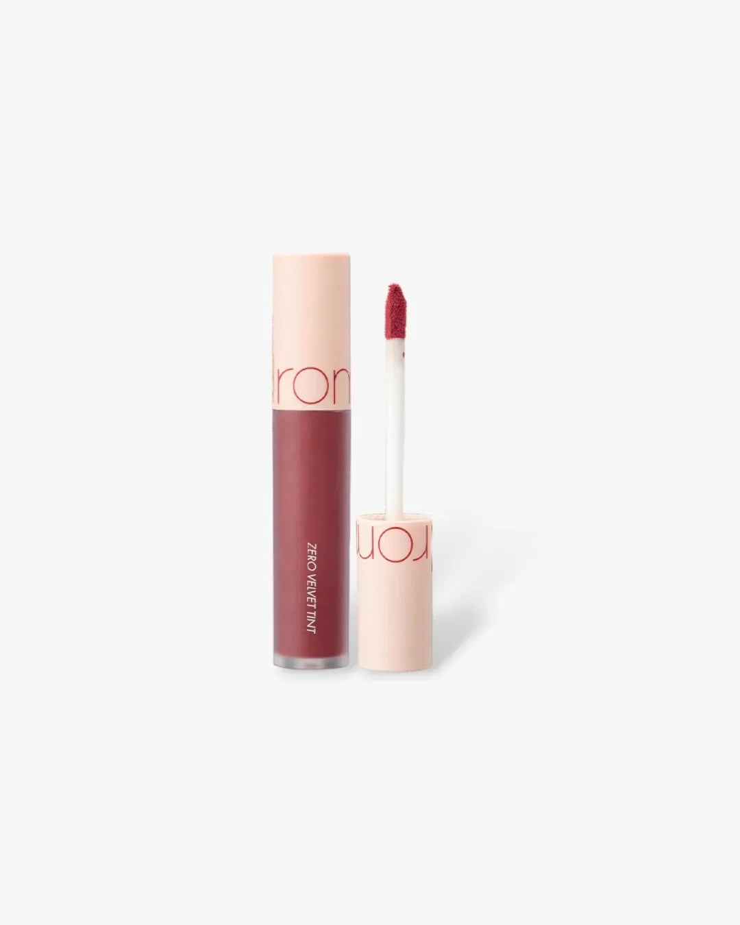 Open tube of Zero Velvet Tint liquid lipstick in burny nude shade with applicator wand